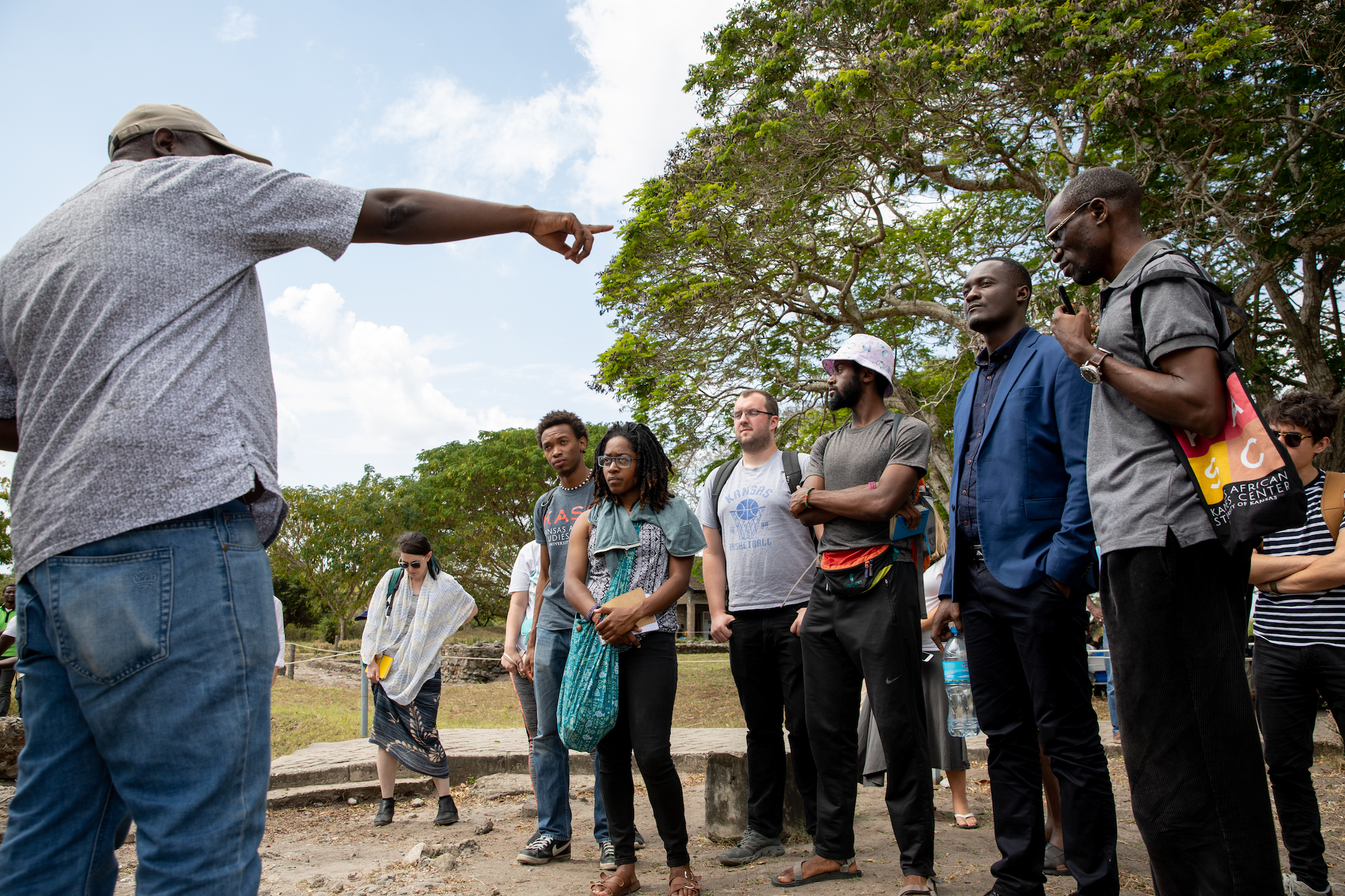 A group of people listening to a man giving instructions